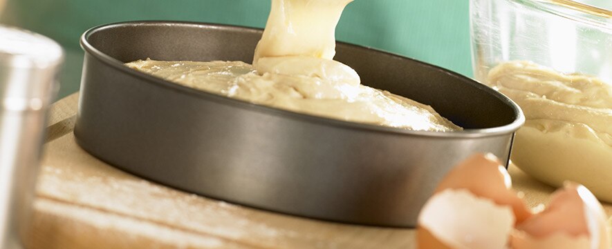 pouring batter in a cake tray